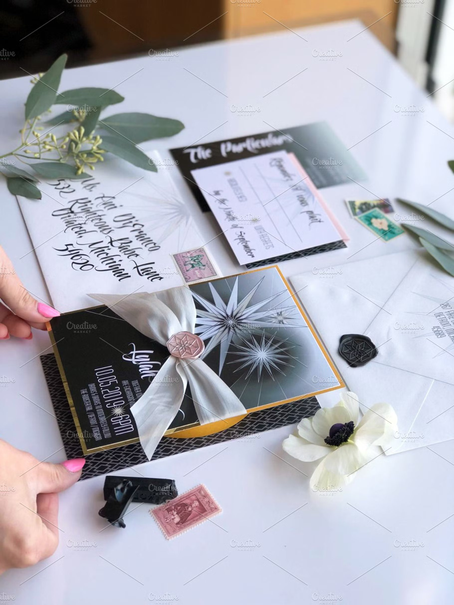 Luxury wedding invitation suite featuring black cardstock, gold foil edges, and a silk ribbon bow – Expert Stationery Guide.